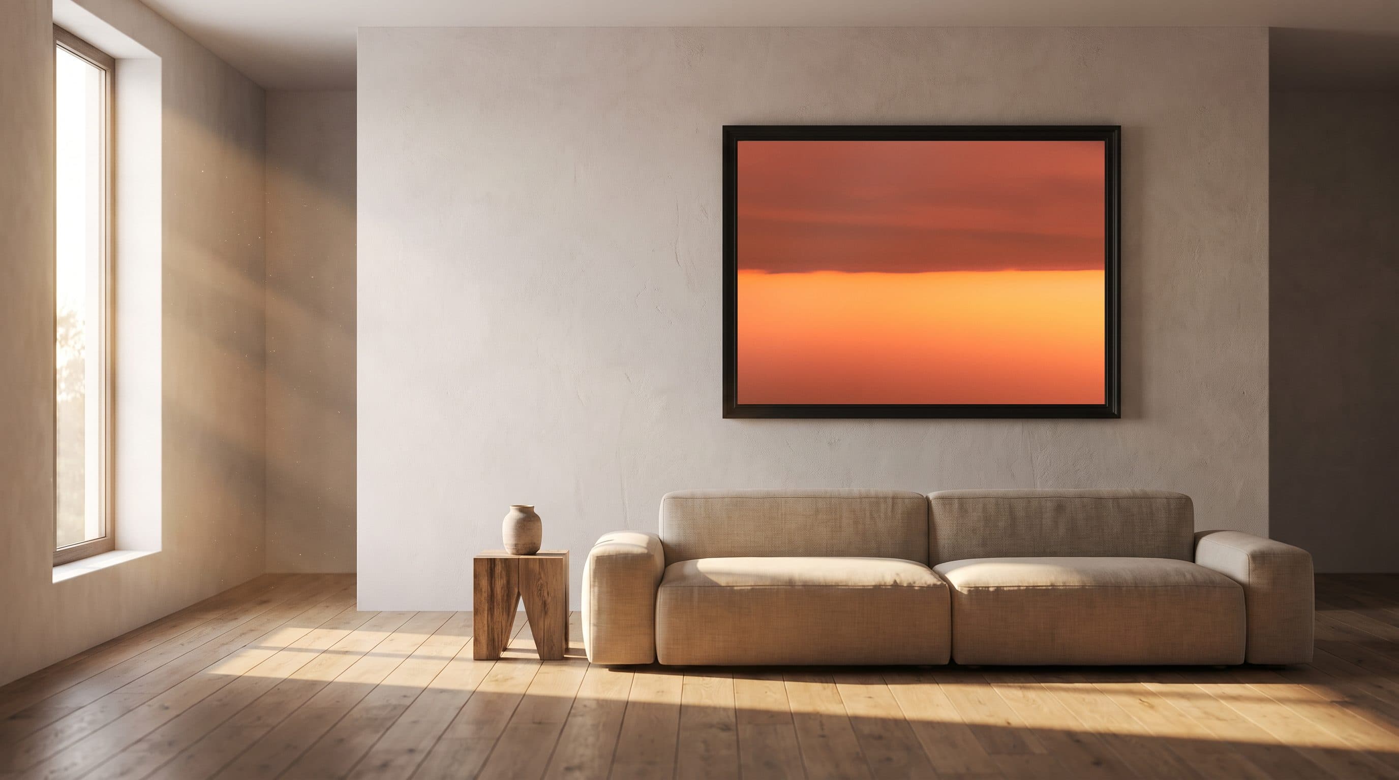 The same photograph, framed, on a plaster wall above a linen sofa
